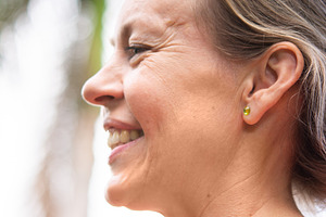 Smiling mature woman profile portrait outdoors after fitness workout, a Sports & Recreation Photo by etorres69