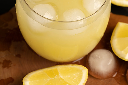 a close-up of lemons and a glass of lemon natural juice, a Photo by MyPhotos