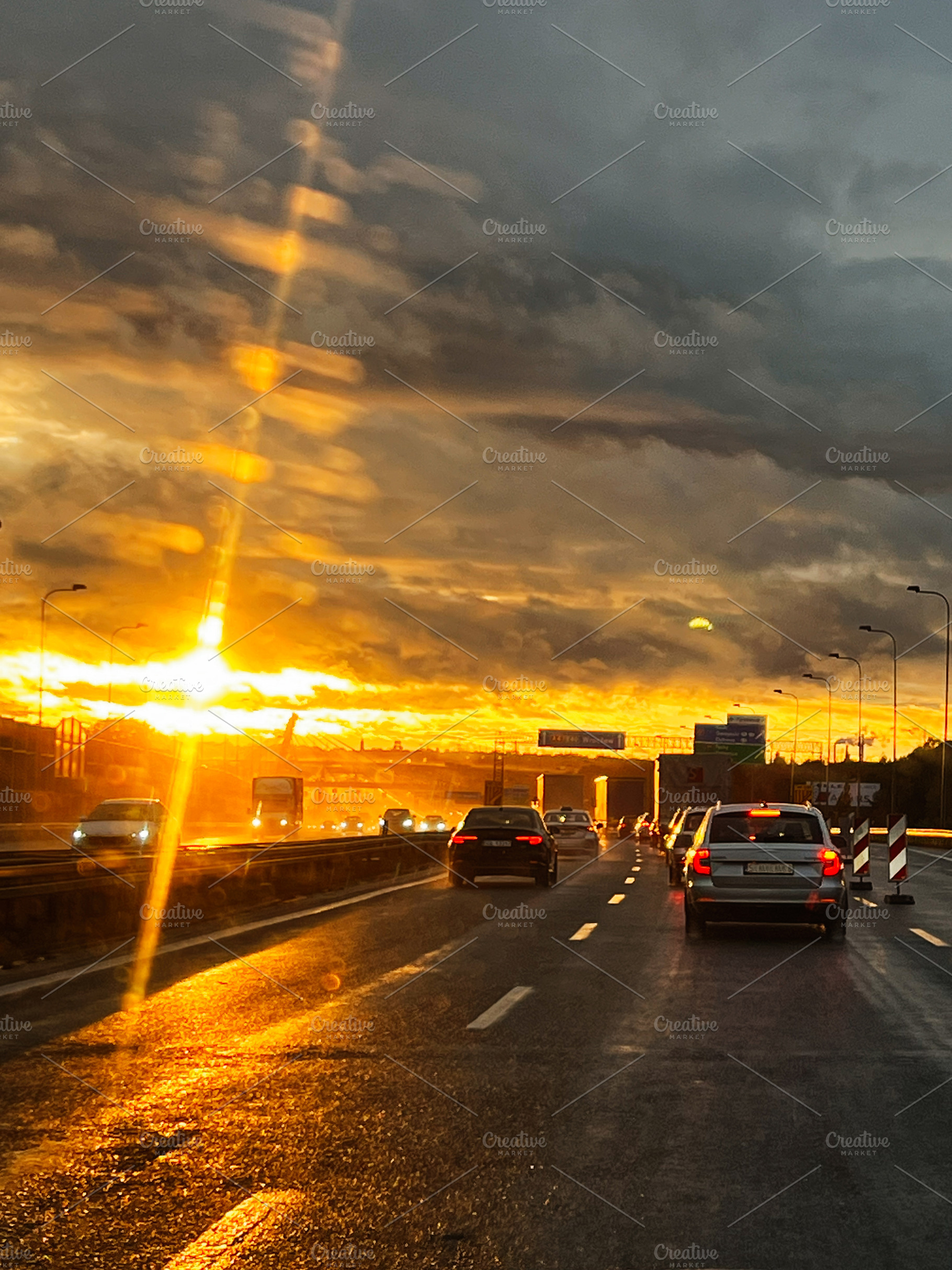 Golden Hour Highway Sunset with Busy Traffic and Wet Road Reflections, a Photo by AS photostudio
