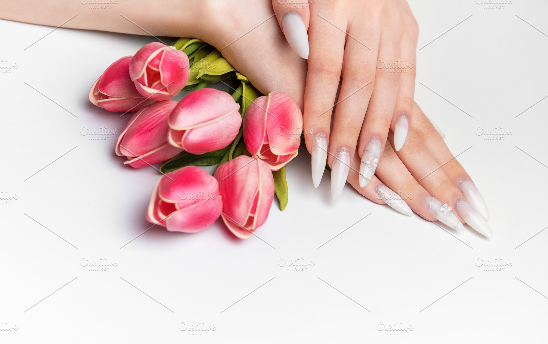 Elegant woman hands with long white manicure nails, a Photo by Olena Rudo