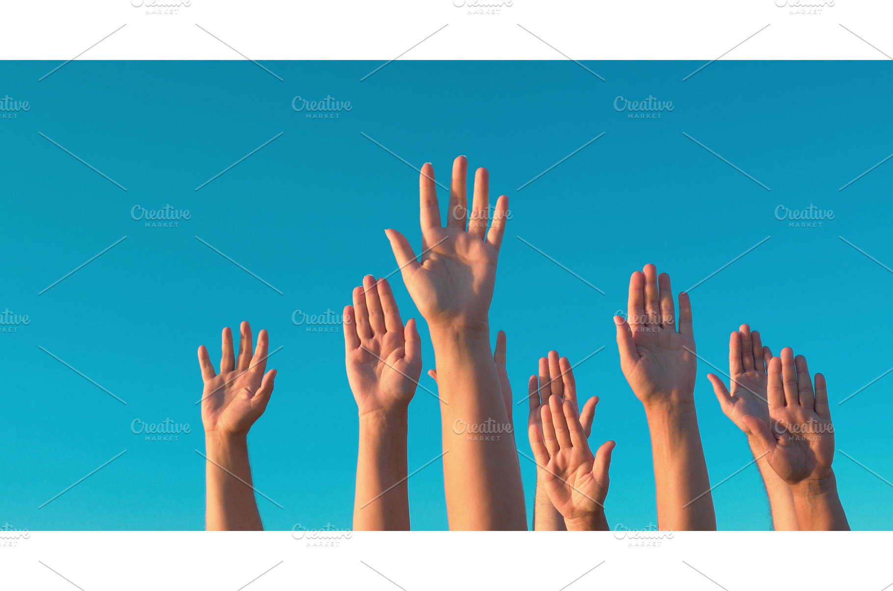 Raised hands against blue sky, a Person Photo by Grey Coast Media