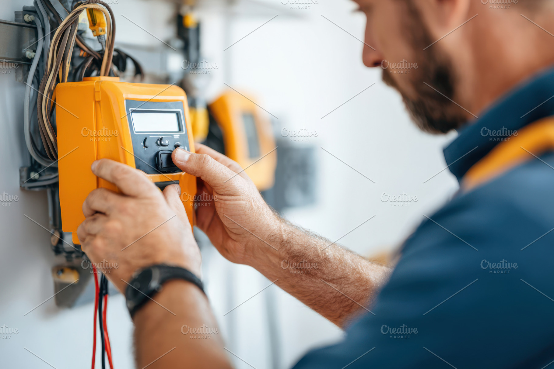 Technician adjusting digital meter in electrical work, an Industrial Photo by AlyaAnd