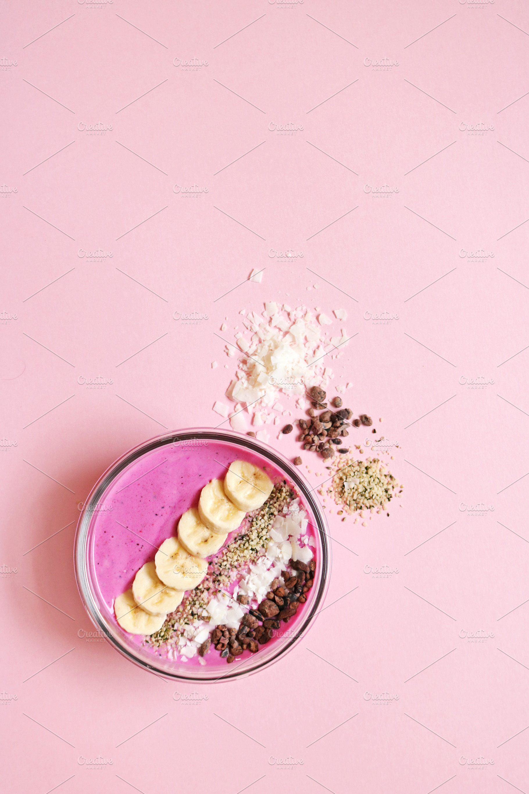 Pink smoothie bowl on pink backgroun stock photo containing smoothie and, a Food & Drink Photo by MDSN Design