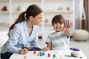 Happy little boy showing colorful palm, smiling to camera, sitting with profess, a Photo by Prostock-Studio (Thumbnail 2 of 2)