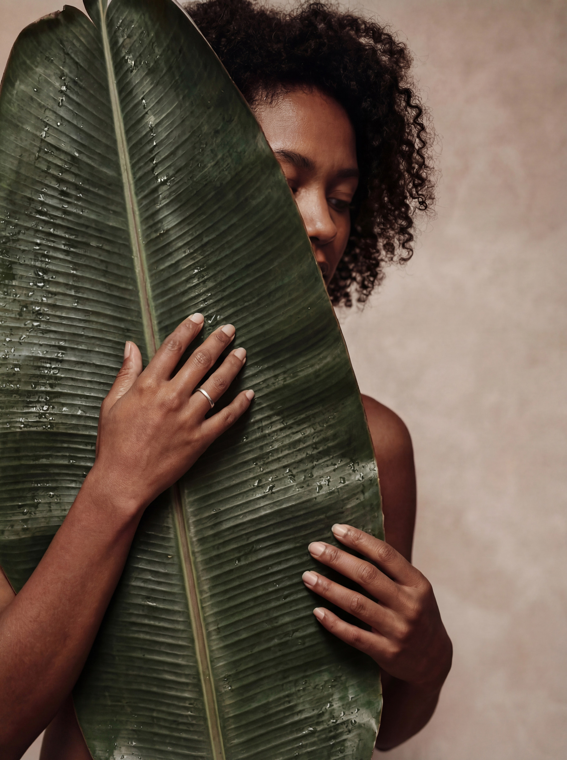 Portrait of Serene Woman with Leaf, a Person Photo by Virgo Studio