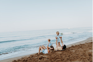 Parents lying in sand and having fun, a Person Photo by HalfPoint