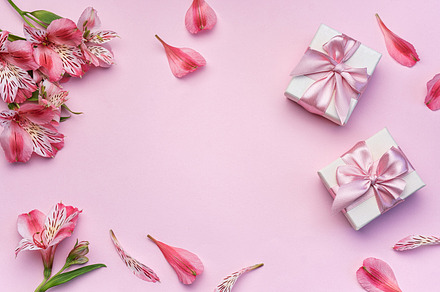 Beautiful Alstroemeria flowers and gift boxes on pink background, a Holiday Photo by Olena Rudo