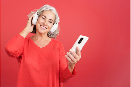 Mature woman listening to music with, a Person Photo by Iván Moreno STOCK PHOTO