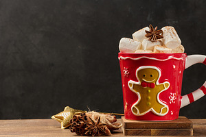 Hot chocolate in a red Christmas mug with a gingerbread man, mar, a Food & Drink Photo by ndanko
