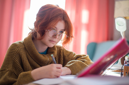 schoolgirl with glasses doing homework., a Photo by Pictures for you!!!!!!!!!