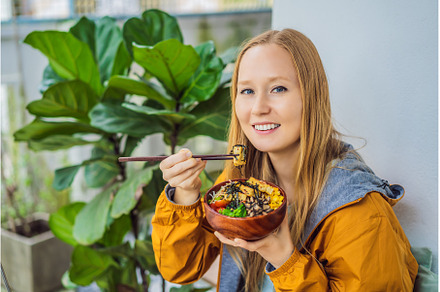 Woman eating Raw Organic Poke Bowl, a Food & Drink Photo by Elizaveta Galitskaya