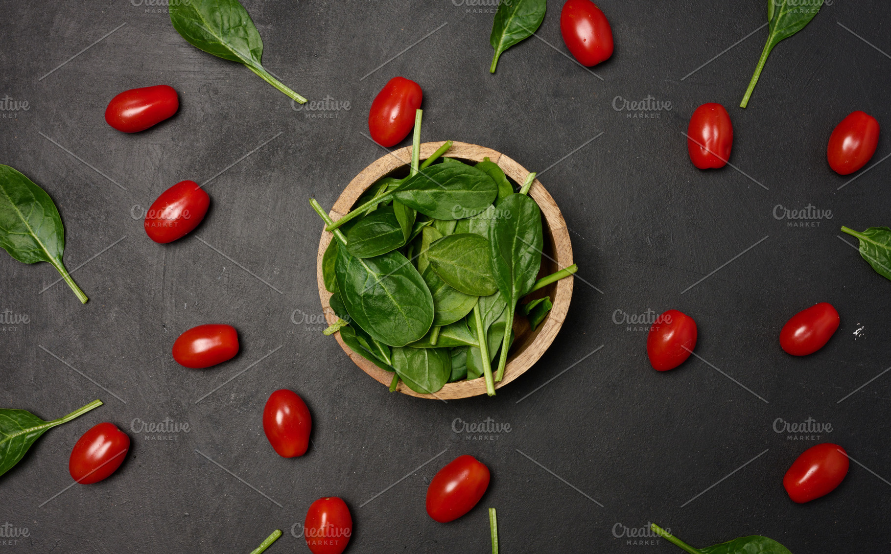 A wooden bowl filled with fresh spinach leaves surrounded by sca, a Food & Drink Photo by ndanko