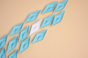 A white origami paper boat stands apart from a group of blue one, a Business Photo by ndanko