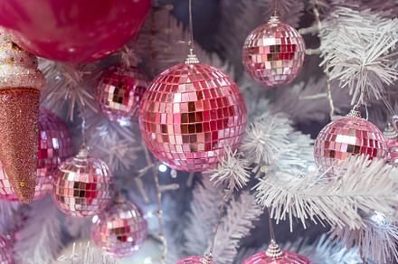 Christmas tree adorned with pink shiny baubles and decorations, a Photo by andreonegin market