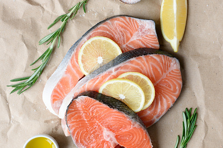 Salmon steaks, lemon, spices and herbs for cooking on paper background., a Food & Drink Photo by The baking man