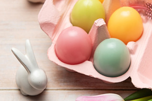 Easter eggs with ceramic bunnies and pink tulips decorating wood, a Holiday Photo by Olena Rudo