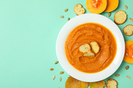 Composition with plate of pumpkin soup on mint background, a Food & Drink Photo by AtlasStudio PRO