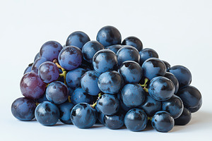 Pile of grapes varieties isolated on, a Food & Drink Photo by Pixeness Studio