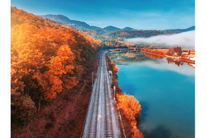 Aerial view of railroad, alpine lake, a Transportation Photo by den-belitsky