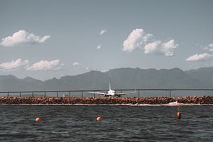 Airplane near sea and mountains, an Industrial Photo by SkyNext