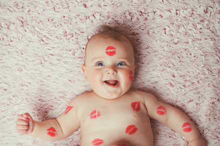 Newborn baby gir filled kisses