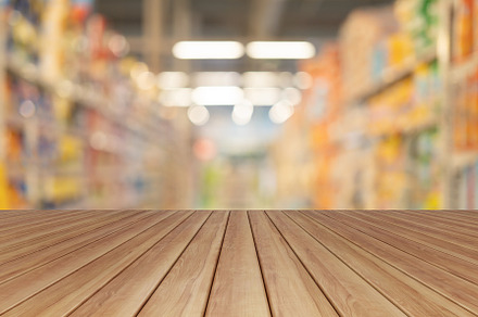 Empty table board with bokeh blurry background of aisle of label, a Background Photo by Tampatra