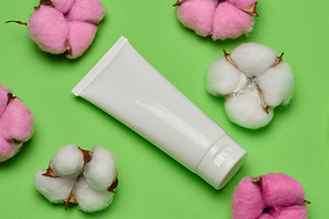 White plastic tube for cosmetics or cream on green background, t, a Beauty & Fashion Photo by ndanko