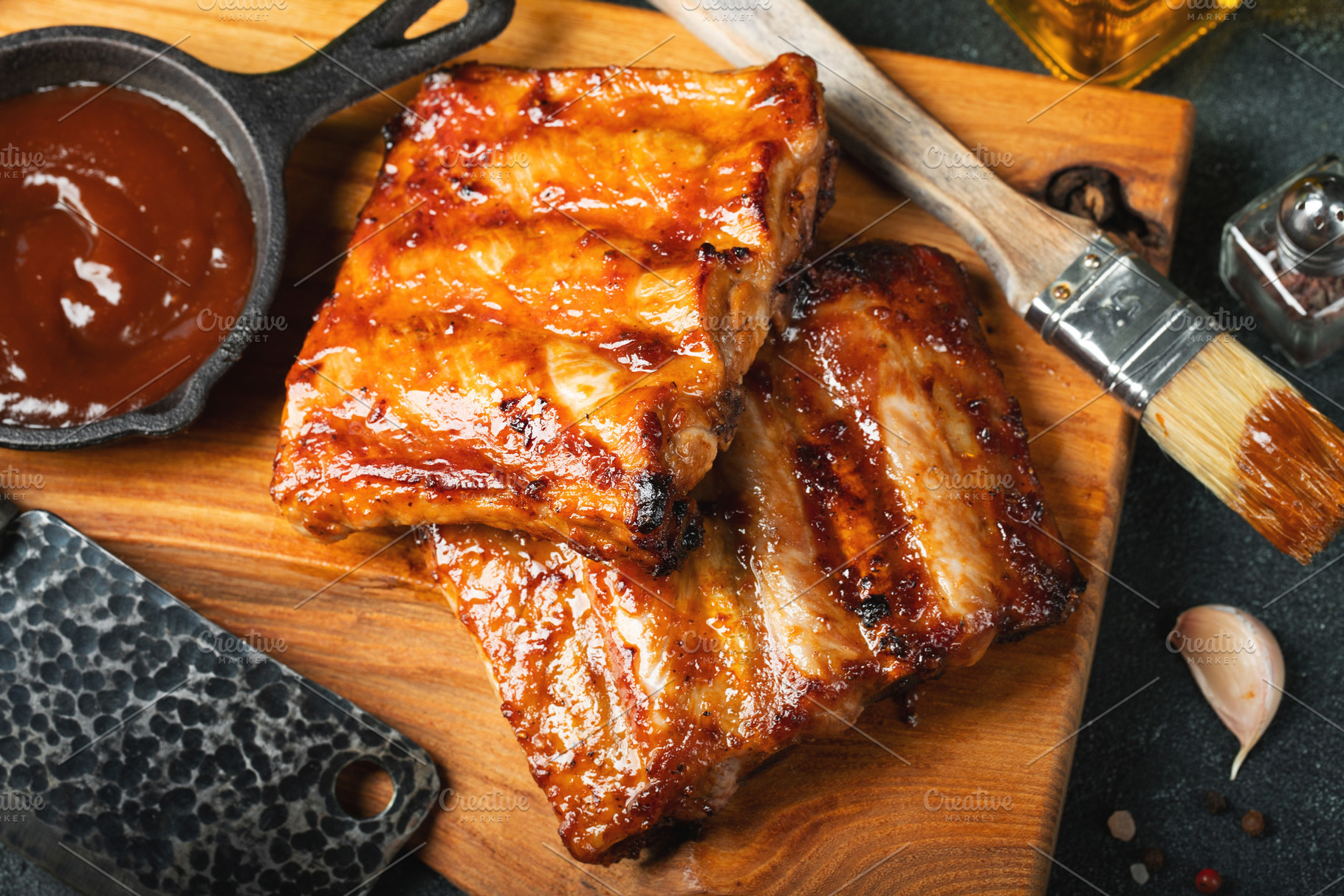 Spicy hot grilled spare ribs from a summer BBQ served with a hot chili pepper a, a Food & Drink Photo by Budarinphoto