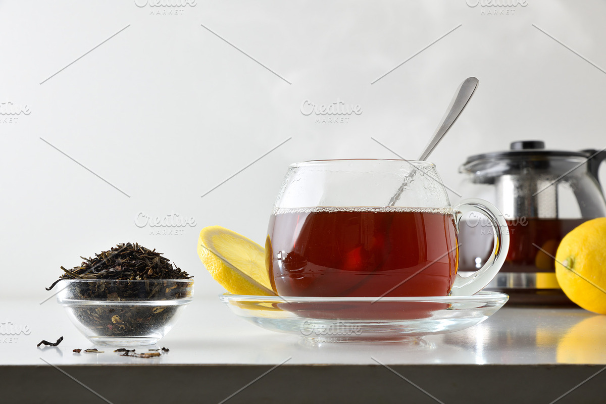 Black tea with lemon on white table isolated front view, a Food & Drink Photo by Davizro's Market (Photo 1 of 2)