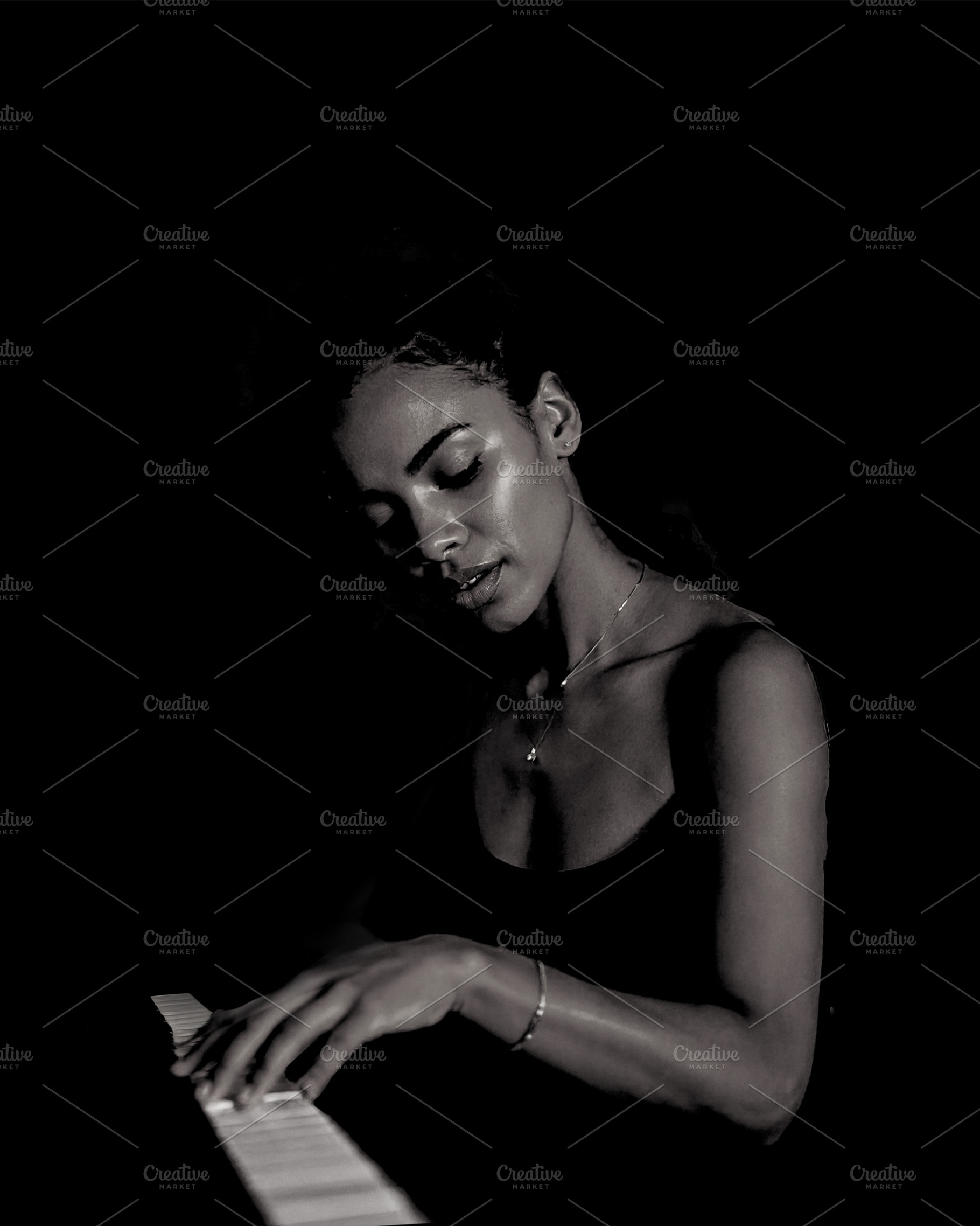 Adult pianist performing at the piano over black background, an Arts & Entertainment Photo by DanFLCreativo