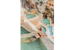Female tourist exploring Grutas, a Holiday Photo by Elizaveta Galitskaya