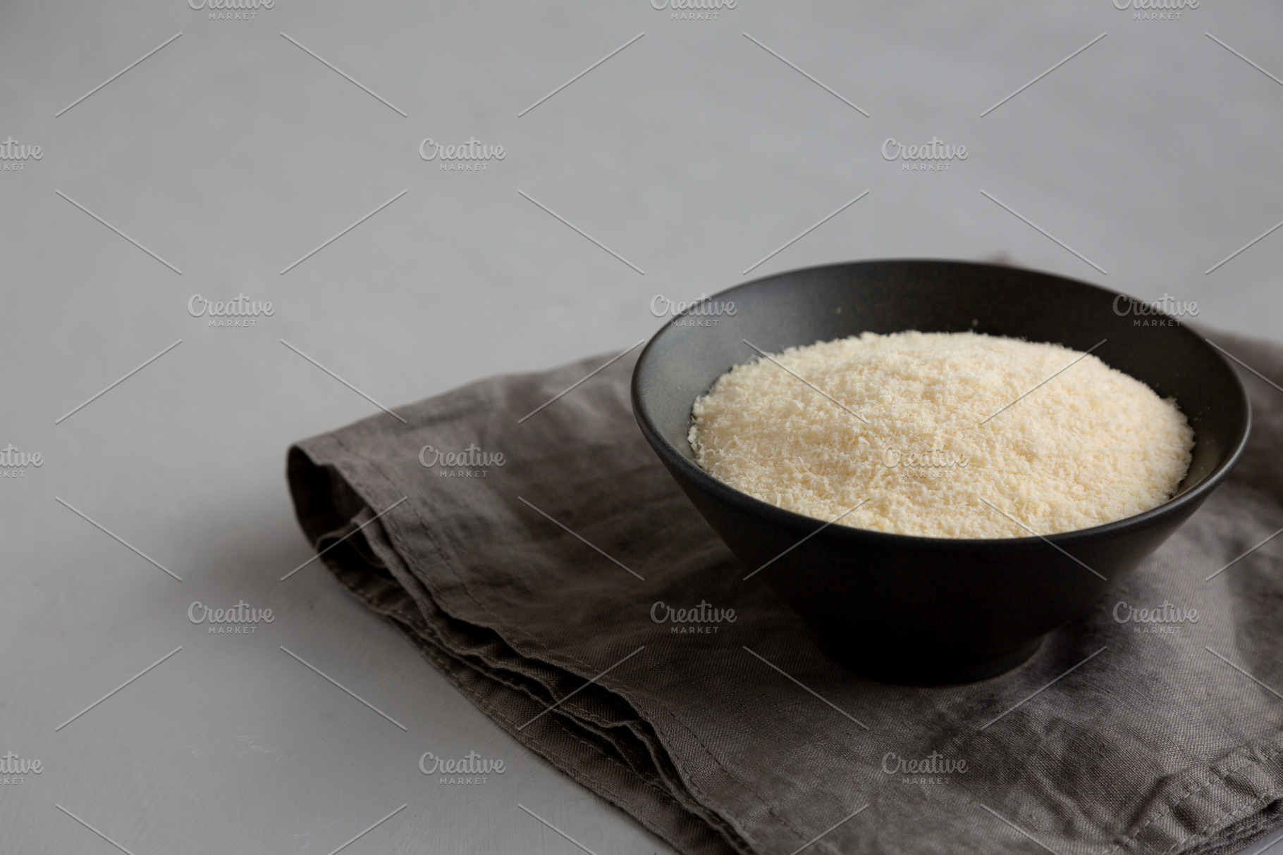 Organic Parmigiano Reggiano Parmesan Cheese Grated in a Bowl, si, a Food & Drink Photo by LiudmylaChuhunova