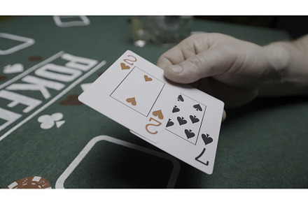 Poker players at a green table with, a Person Photo by Media Whale Stock