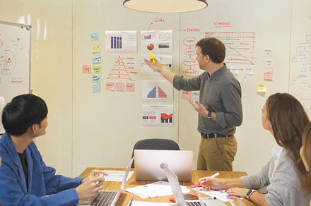 A group of multi ethnic business team talk, communicate, discuss, a Photo by Tampatra