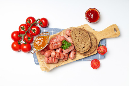 Concept of tasty food, grilled mini sausage, top view, a Background Photo by AtlasStudio