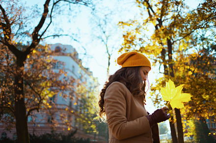 pensive elegant woman in beige coat and hat, a Person Photo by Alliance Images