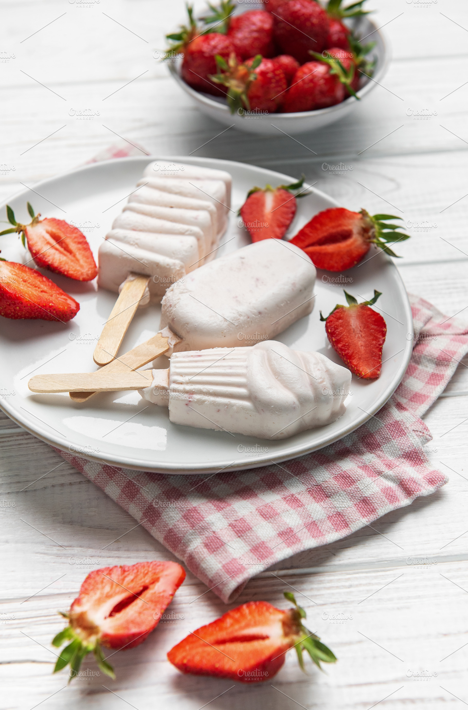 Homemade strawberry ice cream popsicles with fresh fruit, a Food & Drink Photo by Olena Rudo