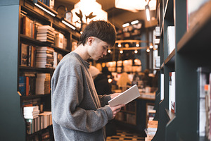 Boy reading book in library