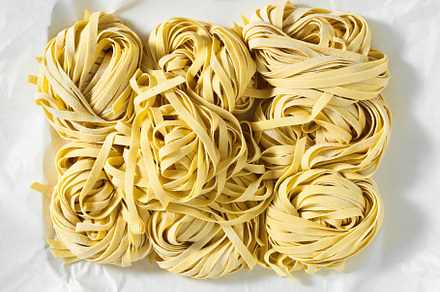 fresh raw Italian tagliatelle pasta, ready for cooking. home mad