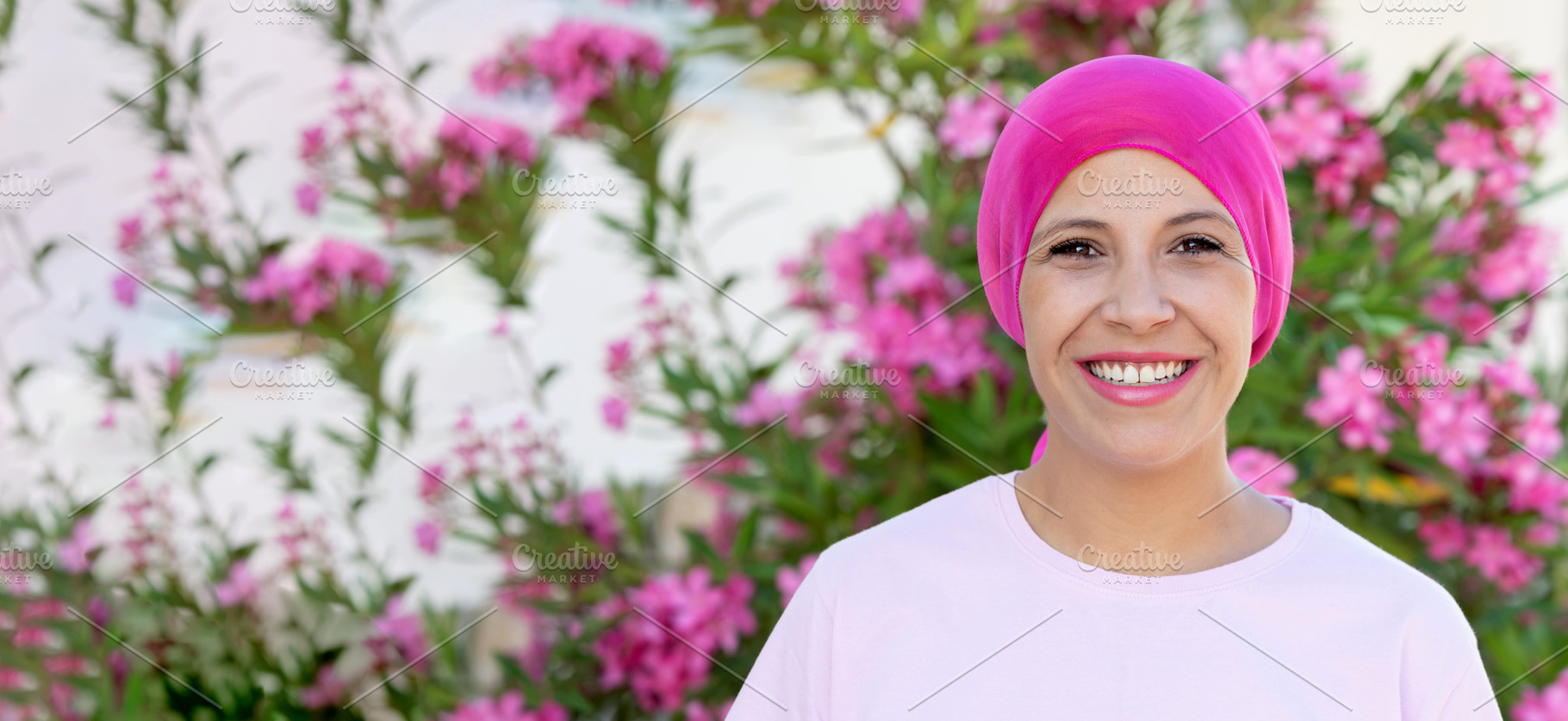 Smiling Breast Cancer Survivor in Pink Headscarf with Garden Flo, a Person Photo by José Manuel Gelpi
