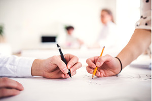 Close up on hands writing on paper, a Business Photo by HalfPoint