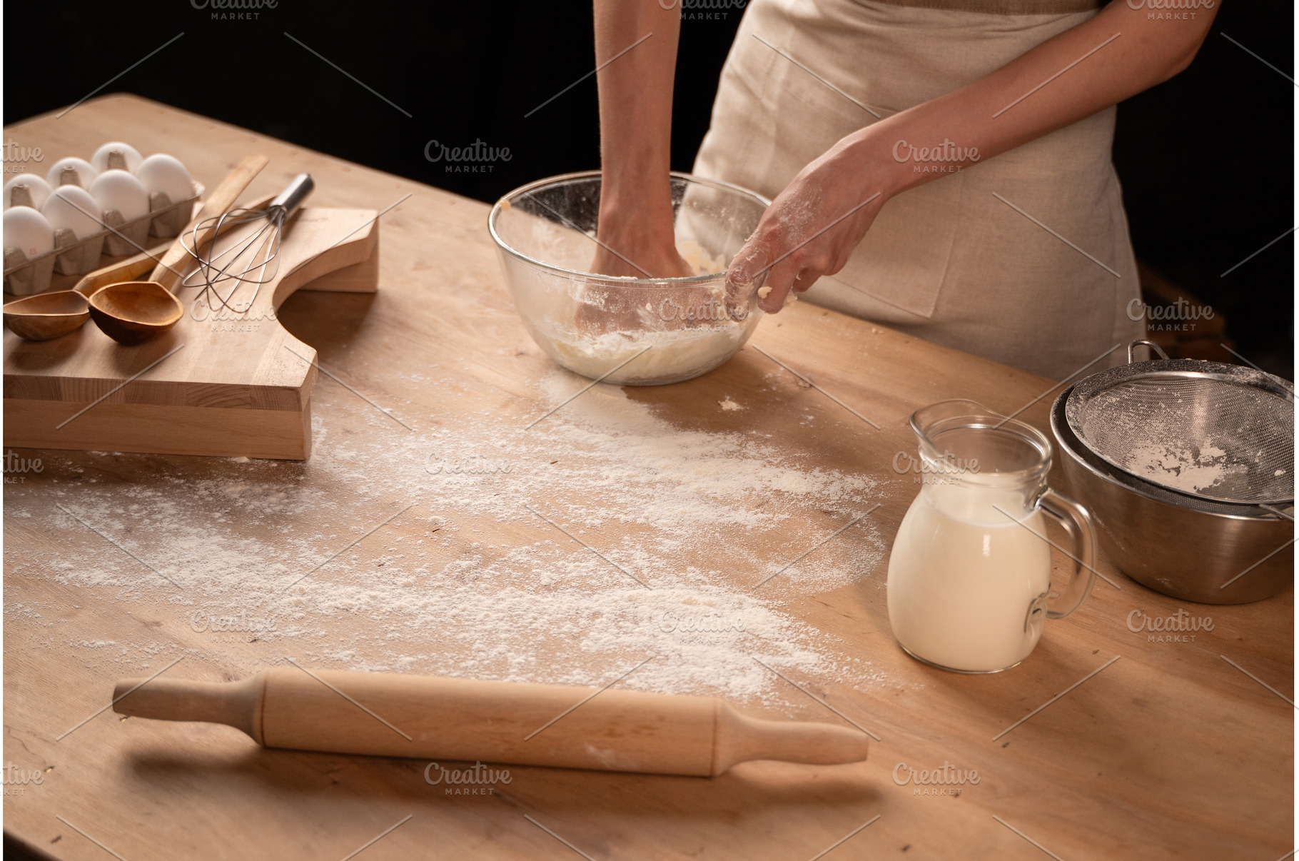 Person kneading dough for baking, a Food & Drink Photo by volodymyrshtun13795