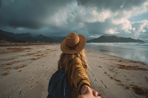 Woman walking on beach holding hand, a Photo by Pixeness Studio