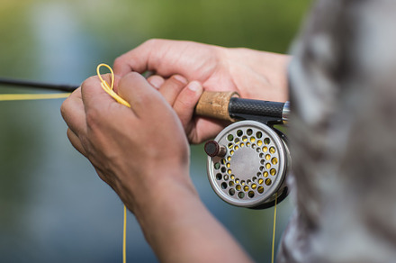 fly fisherman casting his rod on a