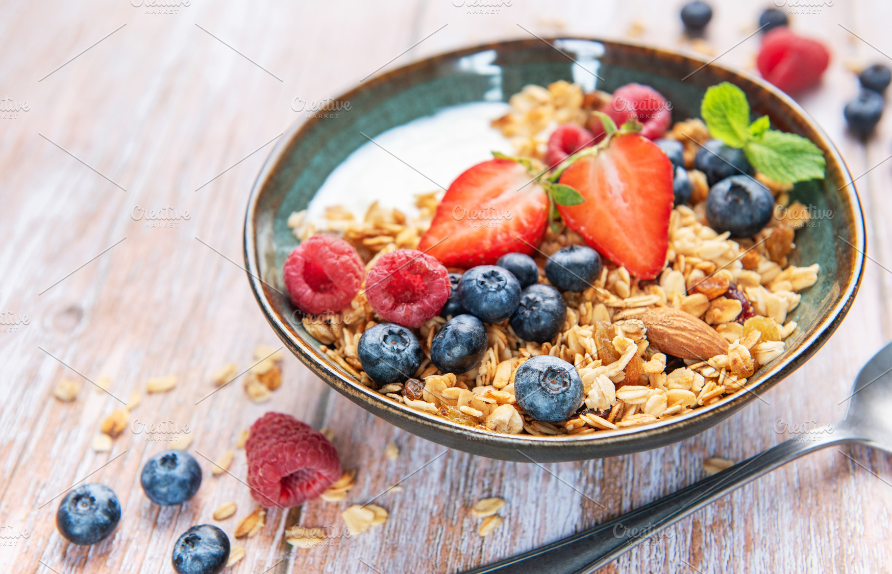 Granola bowl with fresh berries for a healthy breakfast, a Food & Drink Photo by Olena Rudo
