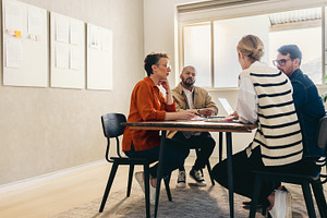 Group of creative businesspeople brainstorming in an office, a Person Photo by Jacob Lund