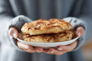 Woman holding plate of freshly baked, a Food & Drink Photo by MistyDay