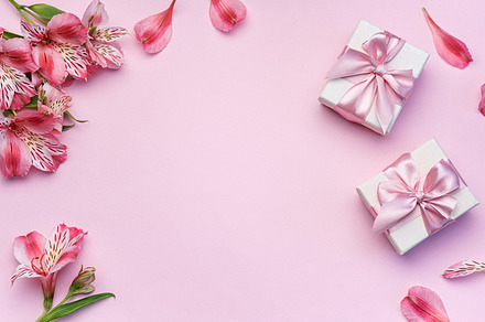 Beautiful Alstroemeria flowers and gift boxes on pink background, a Holiday Photo by Olena Rudo
