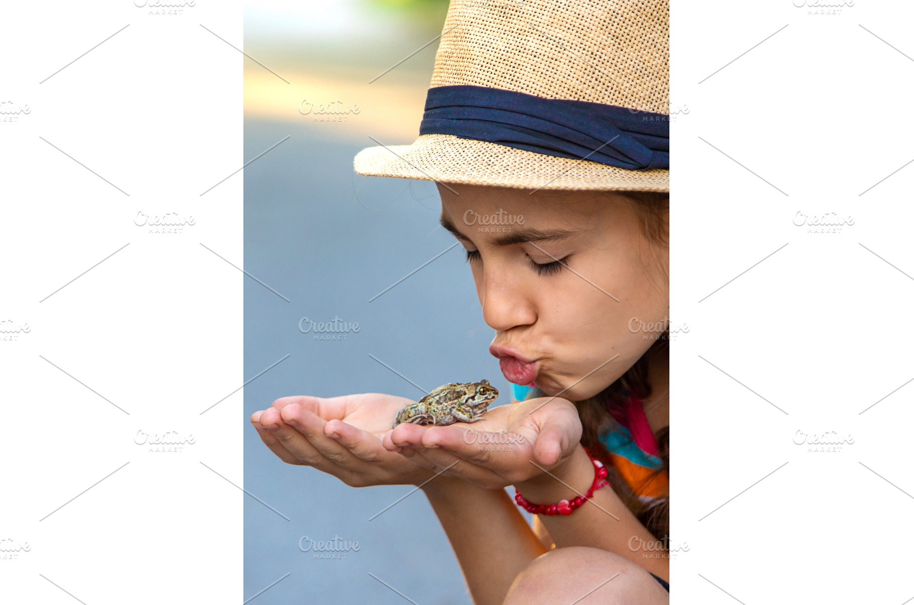 The child is playing with the frog, a Nature Photo by yanadjana