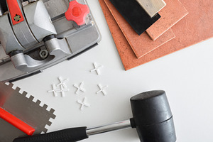 Detail of tile cutter on white table with tools, an Architecture Photo by Davizro's Market